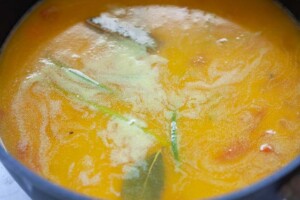 Cooking lobster bisque soup in a soup pot.