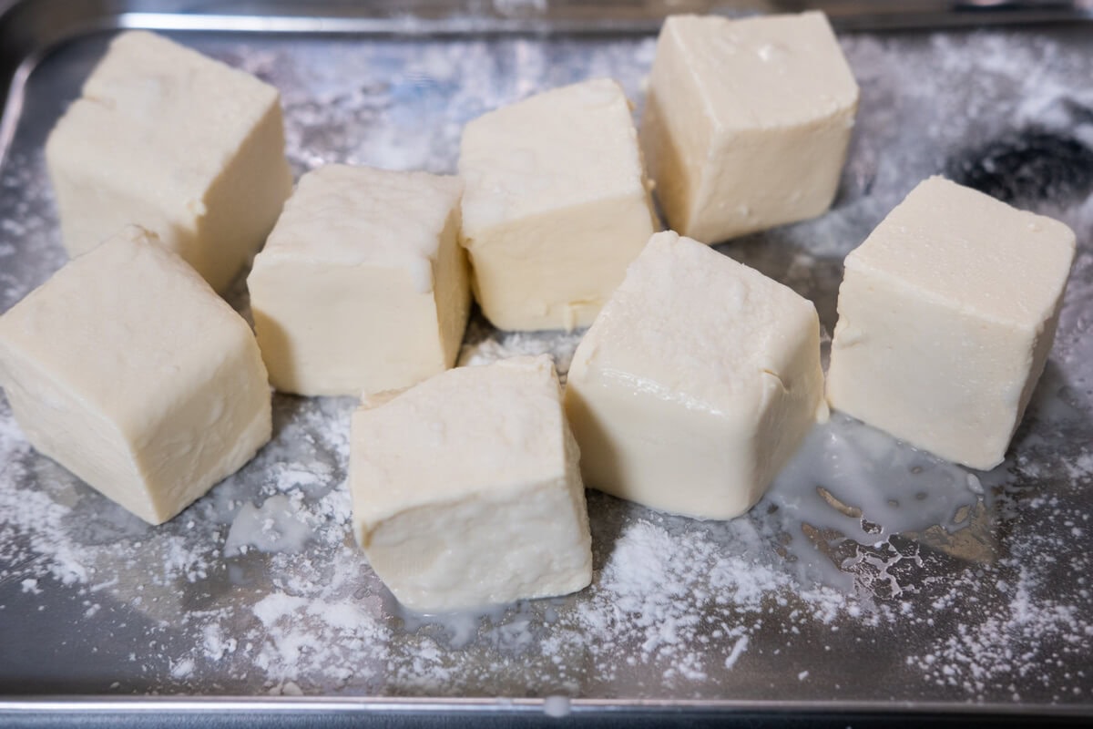 Tofu coated with starch on a plate. 