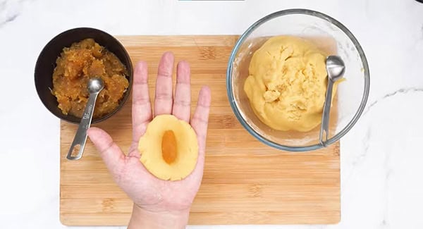 Pineapple filling in the center of the dough.