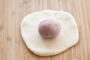 Wrapping a taro bun.