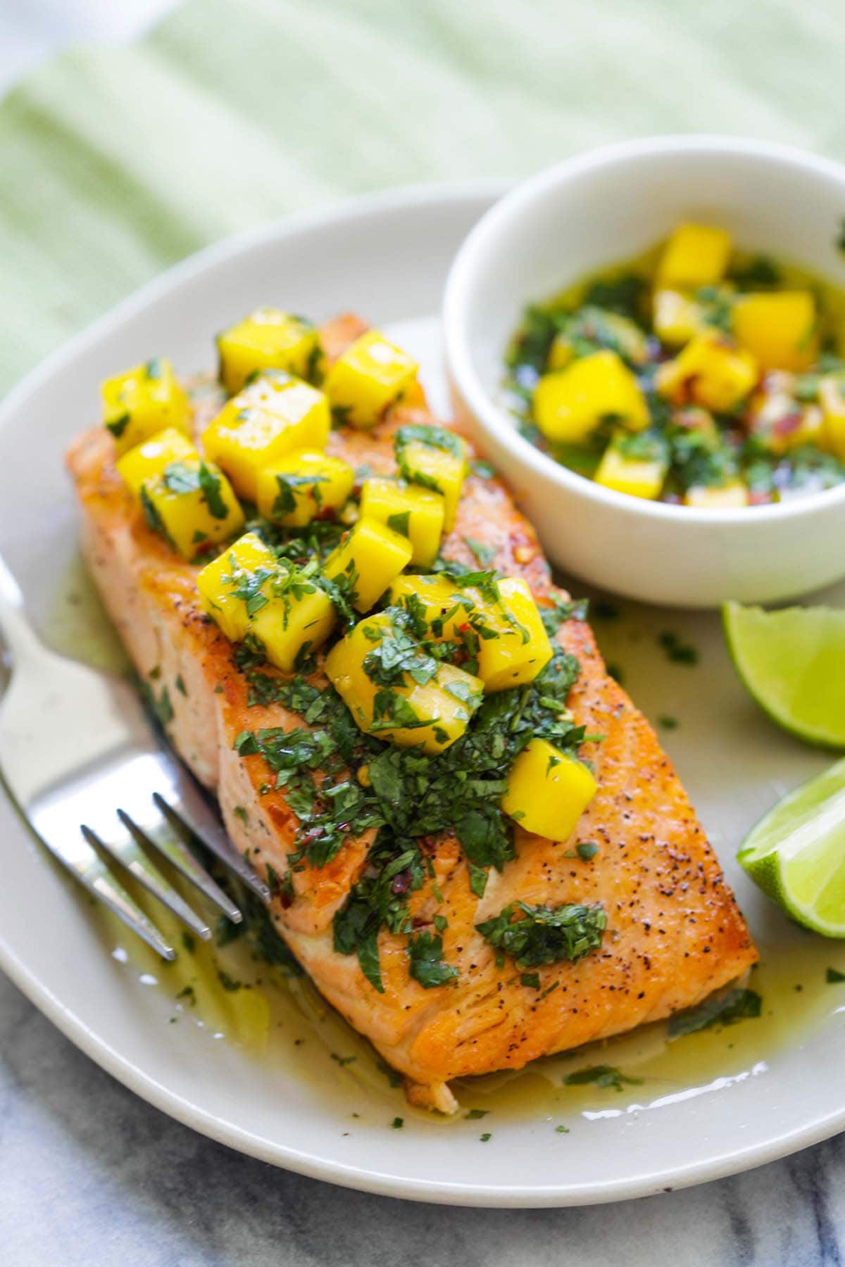 Salmon dish with mango Chimichurri sauce beautifully presented on a plat.e