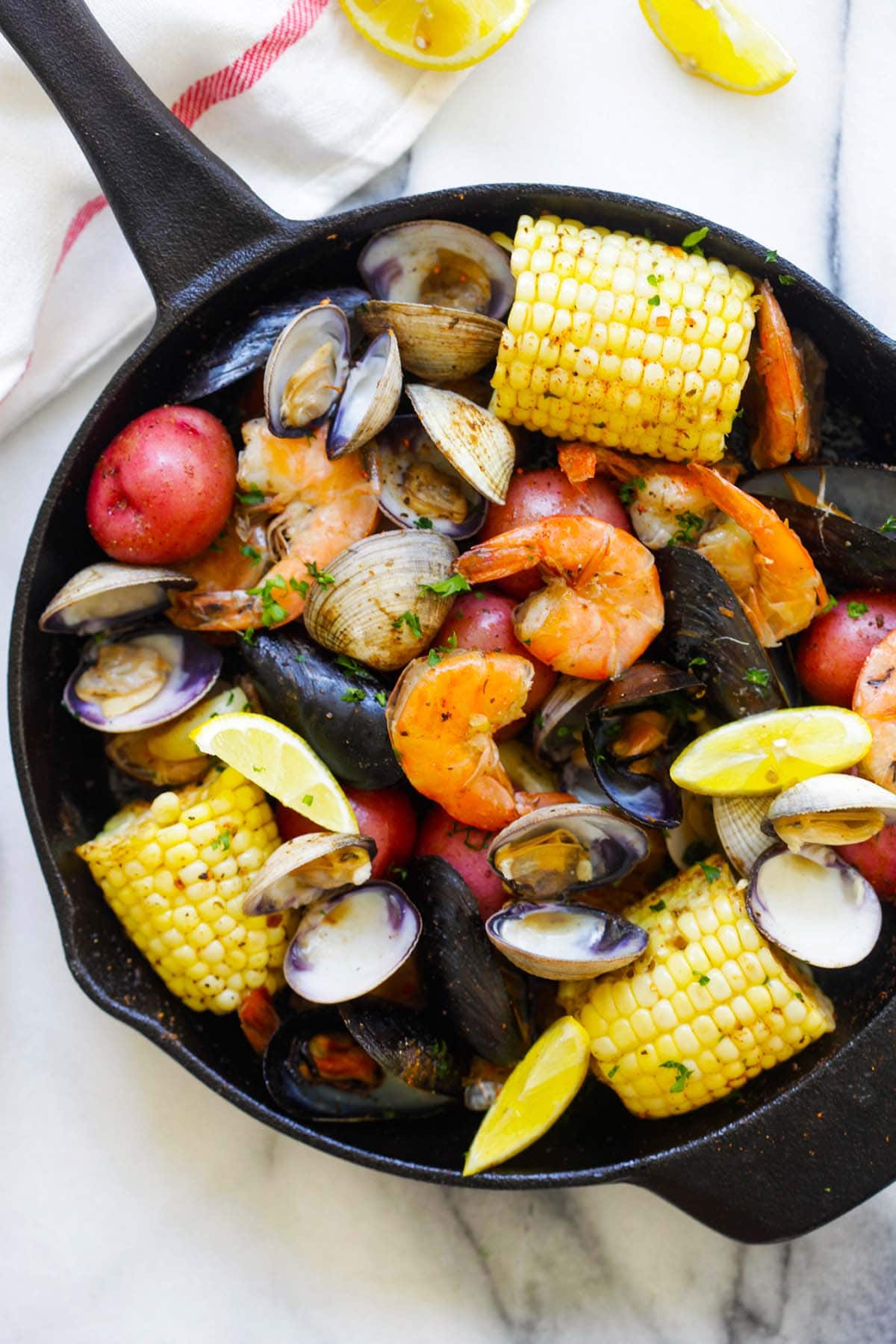 A delicious and easy clambake dish, showcasing a variety of seafood and flavorful ingredients.