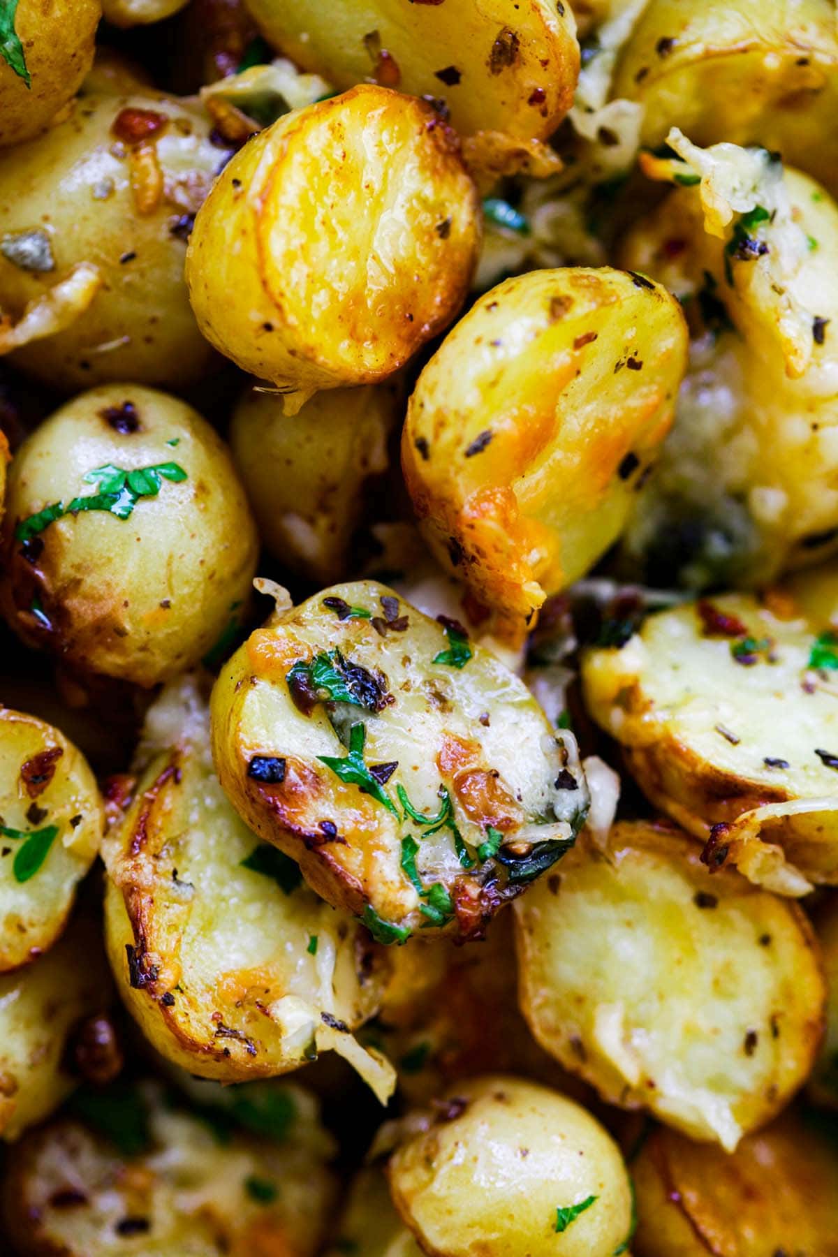 Oven-roasted potatoes with Italian seasoning, garlic, paprika and Parmesan cheese ready to serve.