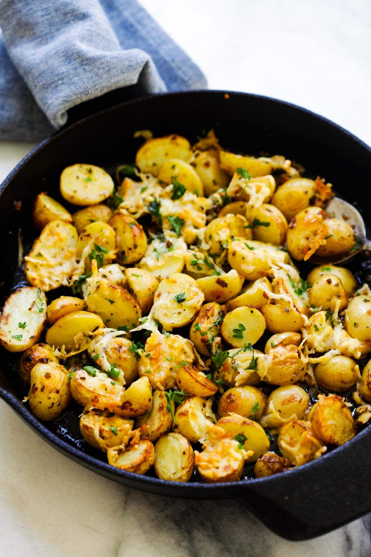 Homemade buttery, cheesy oven-roasted potatoes with Italian seasoning, garlic, paprika and Parmesan cheese.