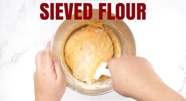 Fold in the sifted flour with the egg yolk batter.