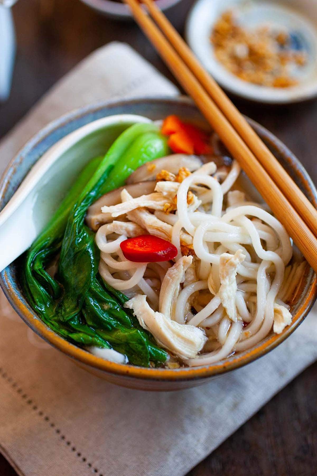 Chinese Chicken Noodle Soup with chicken broth, noodles and bok choy in a bowl.