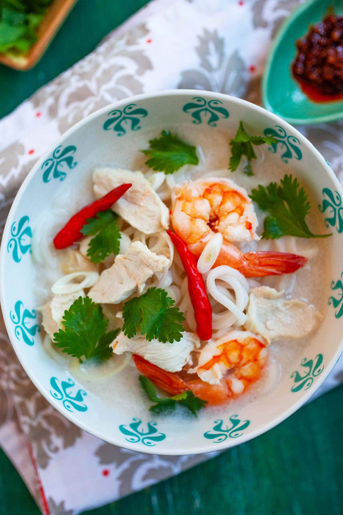 Easy and quick homemade Thai coconut lime chicken soup with noodles served in a bowl.