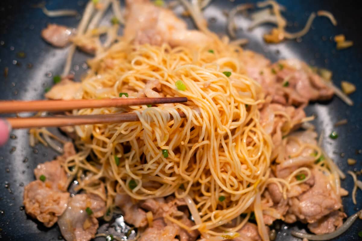 Stir the noodles with all the ingredients in the skillet, then add salt.