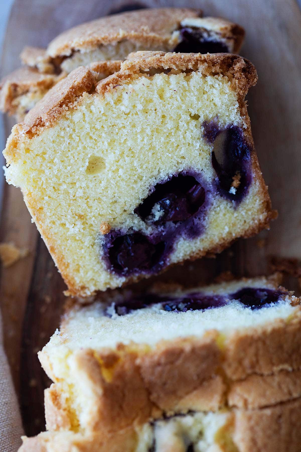 A slice of golden-brown crust and vibrant blueberries cake.