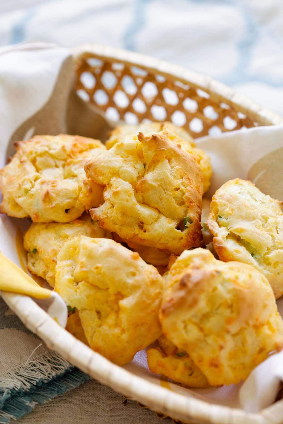 Easy and delicious homemade French puff pastry made with cheddar cheese and chopped scallions served in a basket.