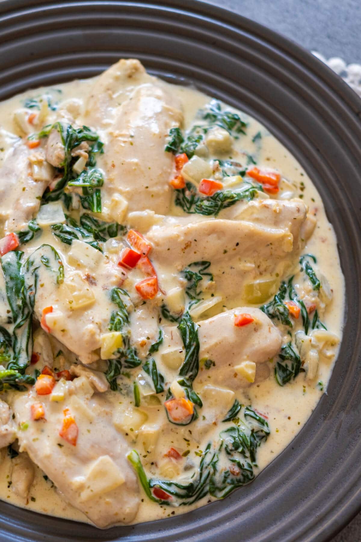 Garlic butter chicken in a creamy sauce served in a black plate. 