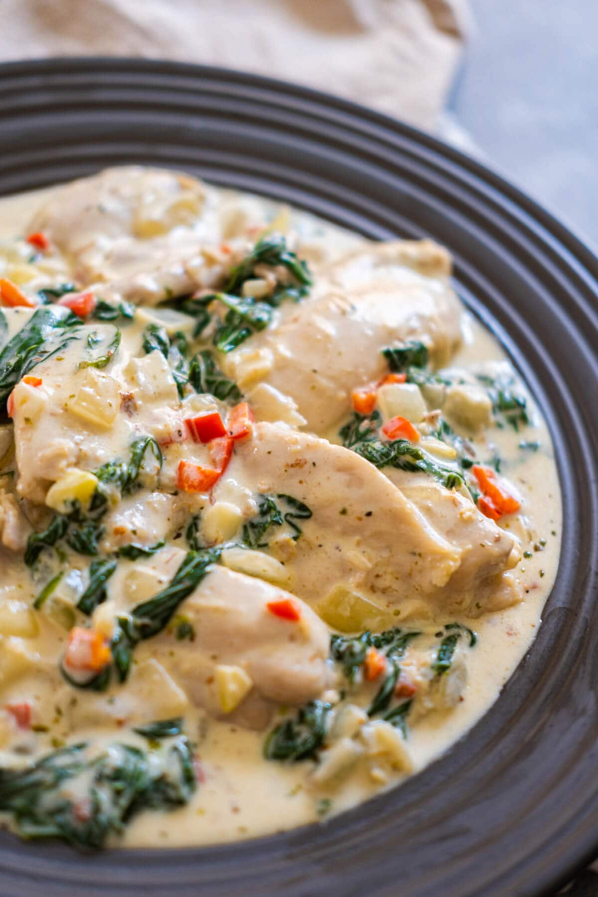 Chicken pieces bathed in rich and flavorful garlic-infused butter sauce beautifully presented in a black plate. 