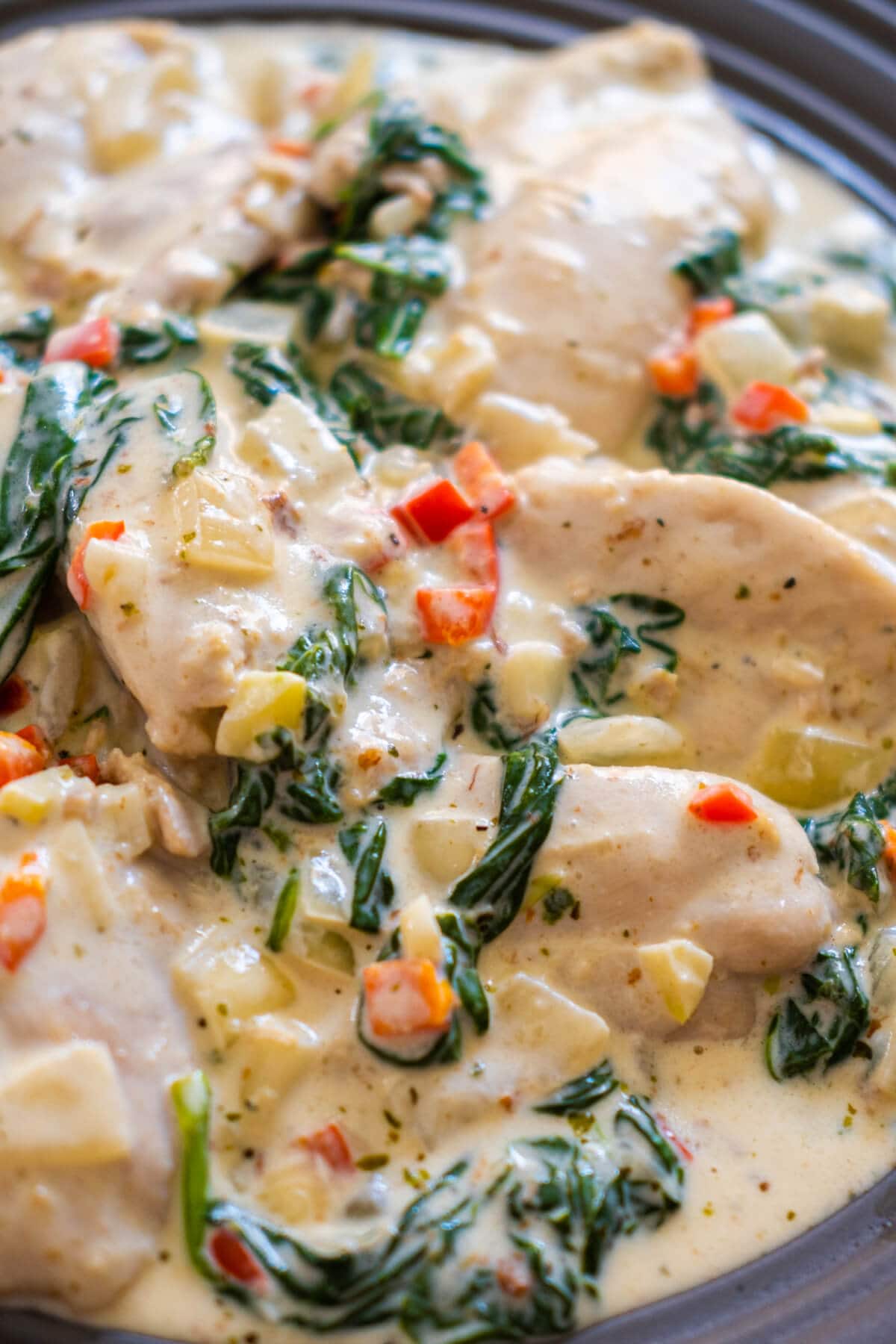 Close up shot of succulent chicken pieces in a luscious, golden-brown buttery sauce. 