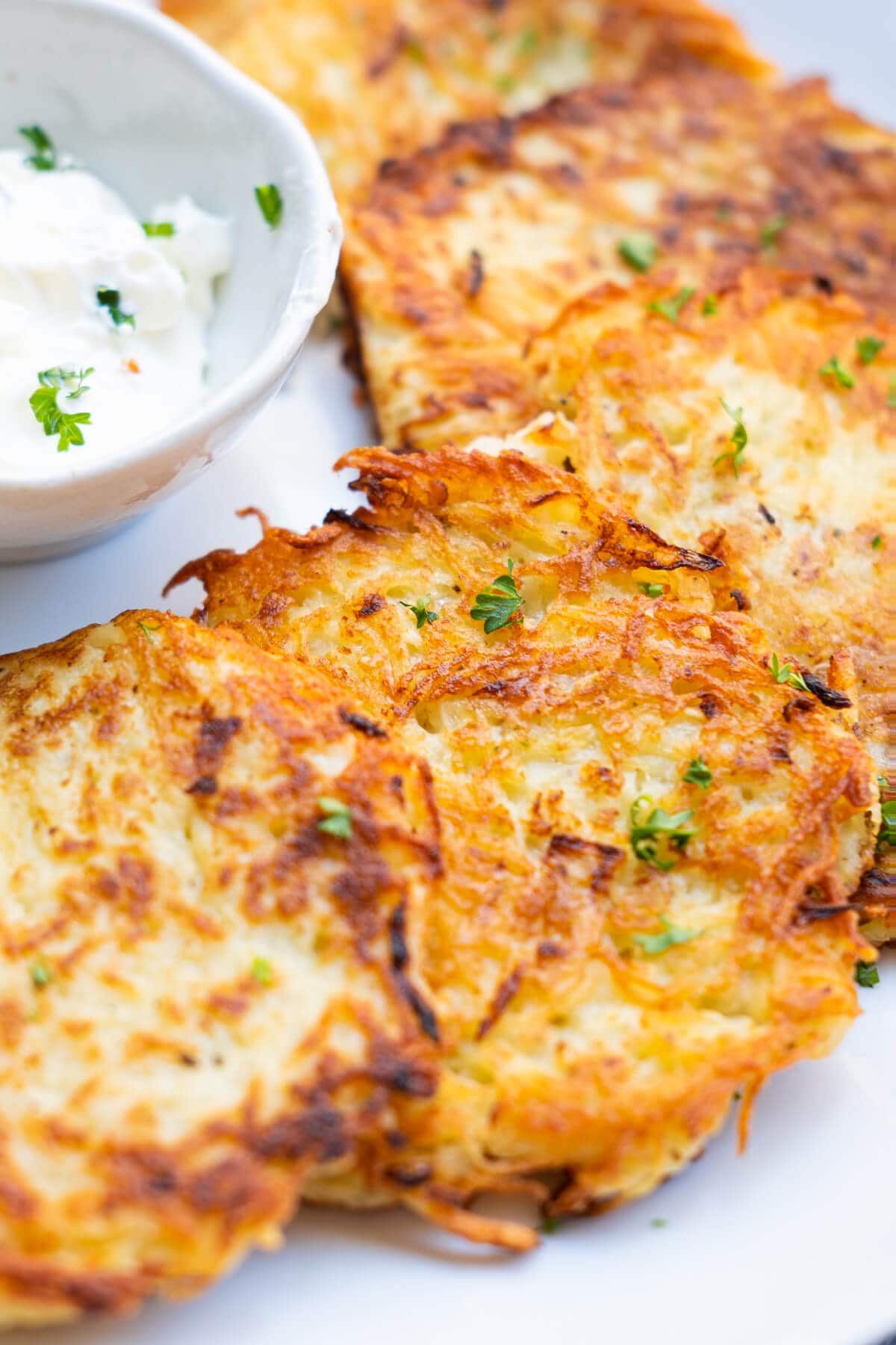 A close up shot of crispy golden-brown potato pancakes. 