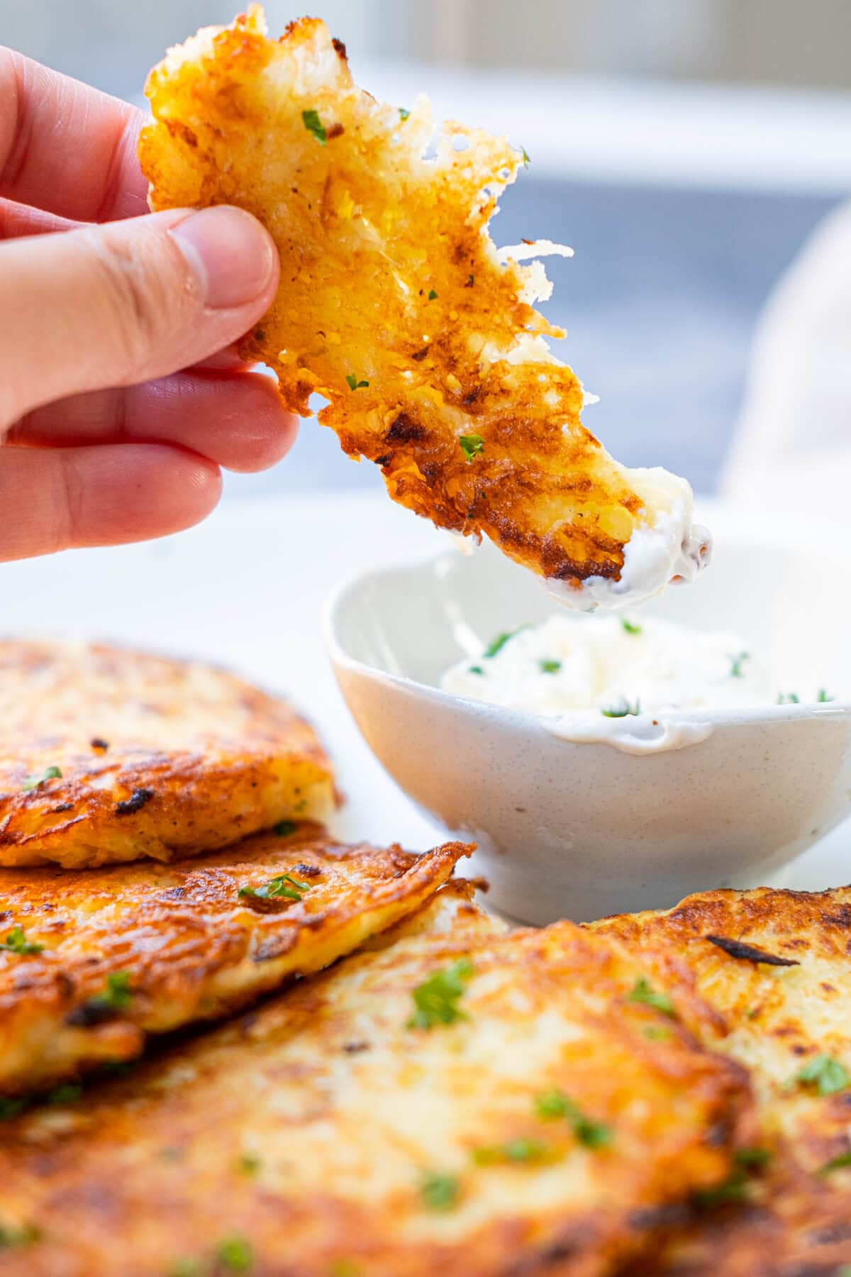 Potato pancake dipped in sour cream.