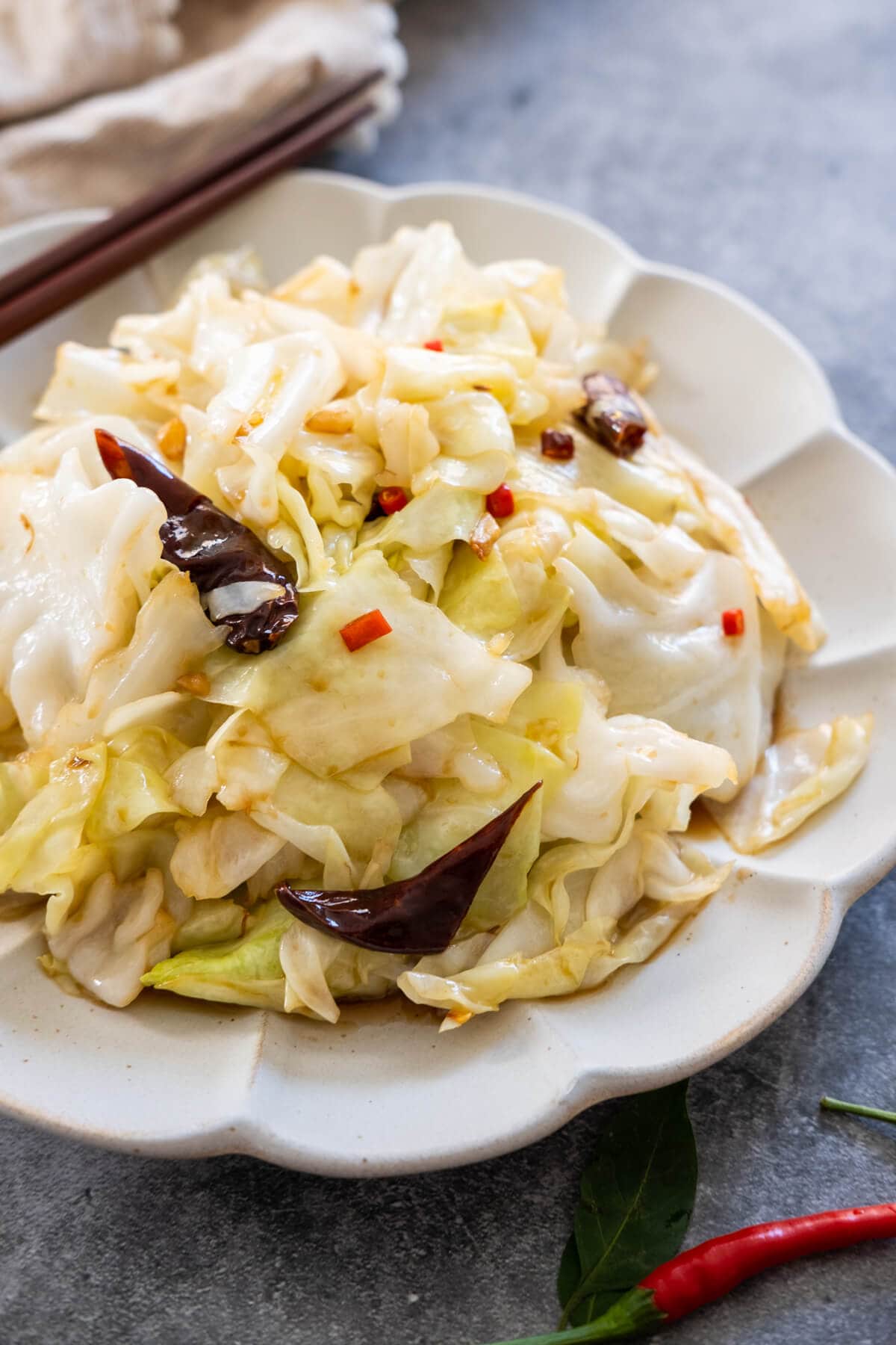 A plate of Chinese cabbage cooked in Sihuan way served with dried chili in a plate. 