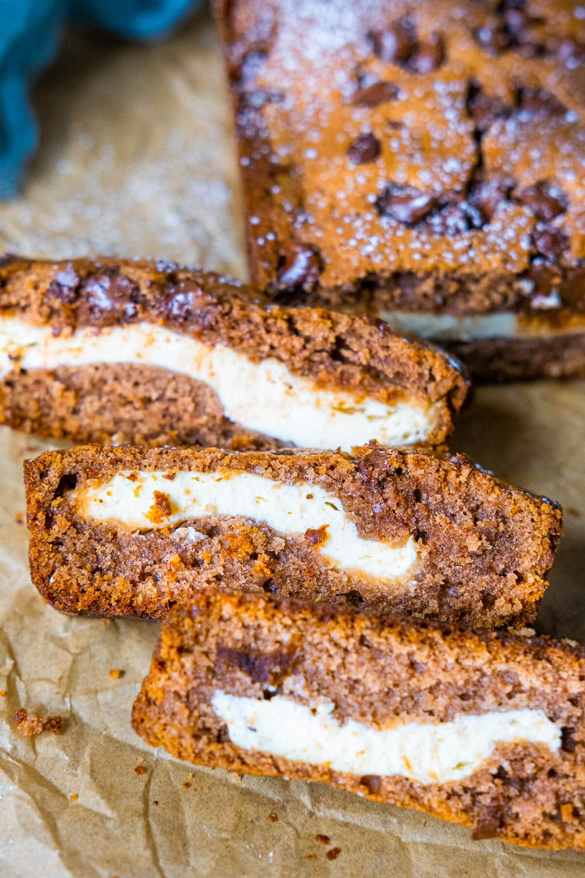 Slices of chocolate cake, showcasing layers of rich and moist chocolate cake with a lavish cream cheese frosting in between. 