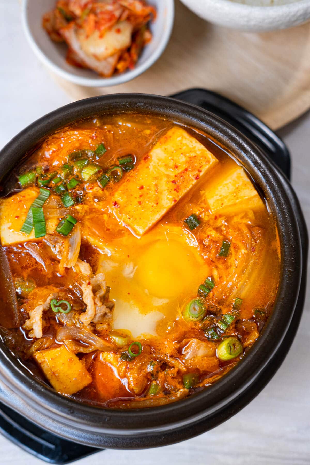 A bowl of Soondubu served in a black claypot. 