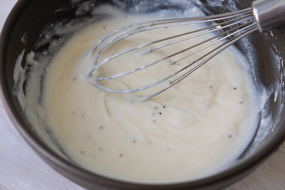 All dressing ingredients combined  being whisked in a bowl. 