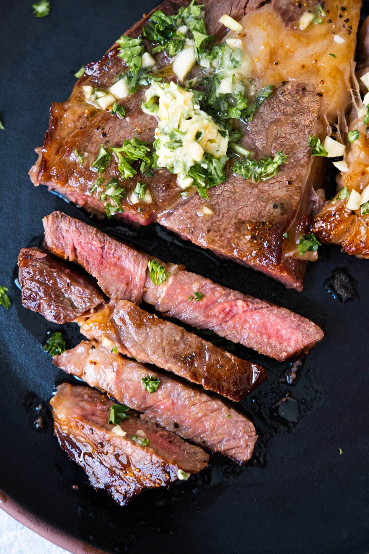 Juicy Wagyu beef served with garlic butter on top and sprinkled with chopped parsley.