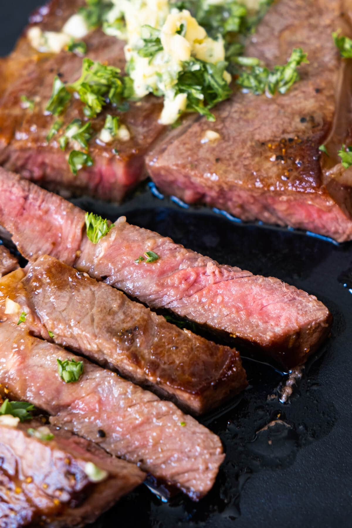 Soft and tender Wagyu beef cut into slices and topped with garlic butter and chopped parsley. 