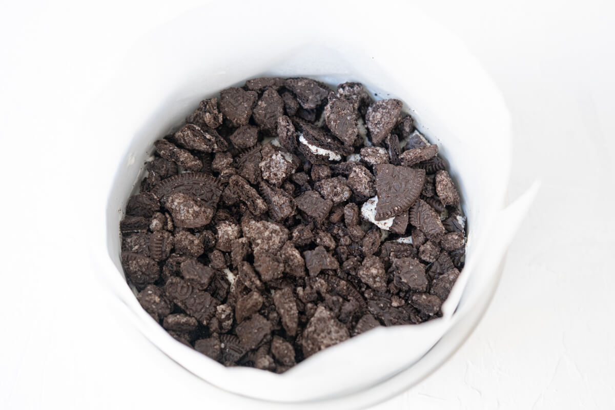 Oreo crumbs laid on top of ice cream layer. 