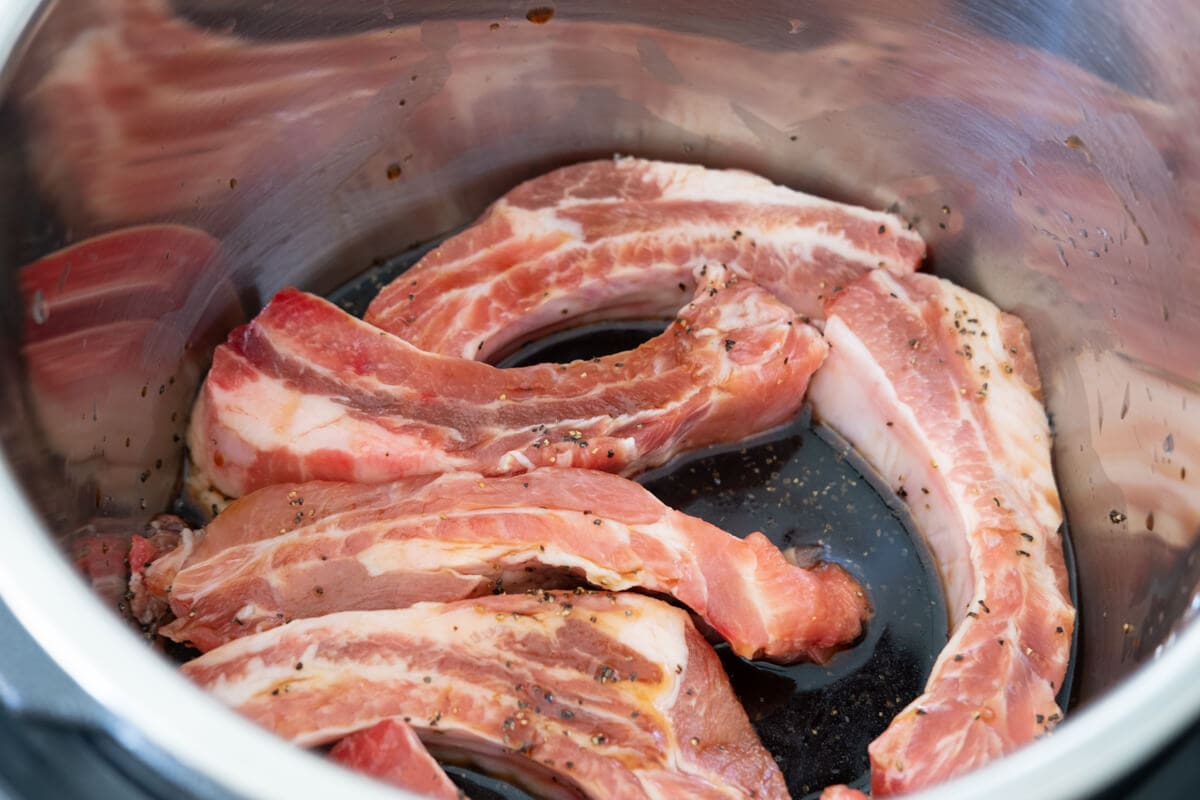 Baby ribs placed in a slow cooker with teriyaki sauce. 