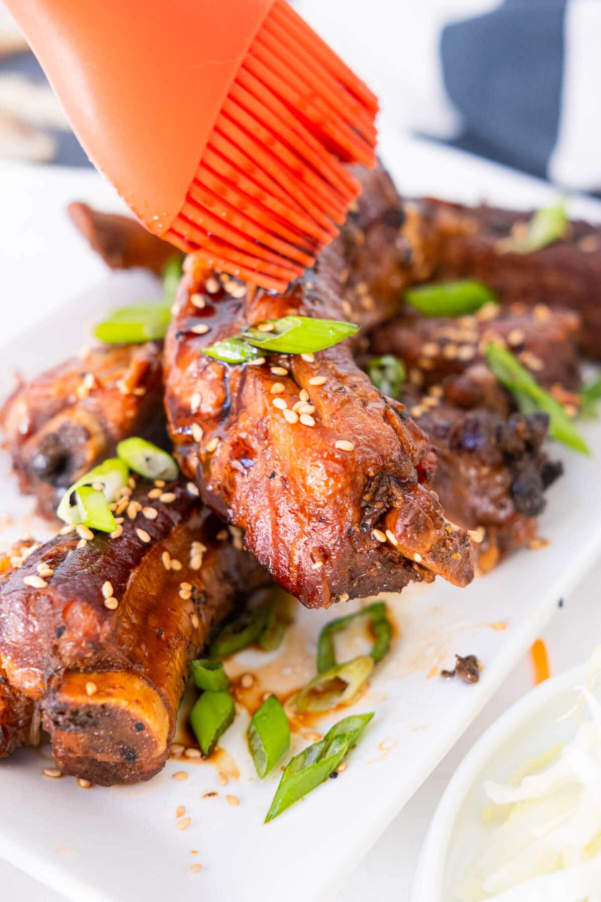 Cooked teriyaki ribs brushed with teriyaki and balsamic sauce.