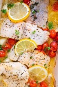 Healthy baked catfish made with cherry tomatoes, lemon and thyem.