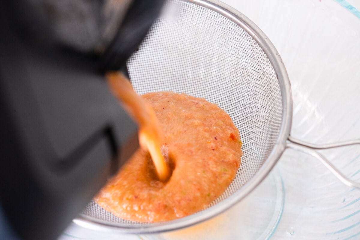 Soup strained out with a strainer into 
a bowl. 