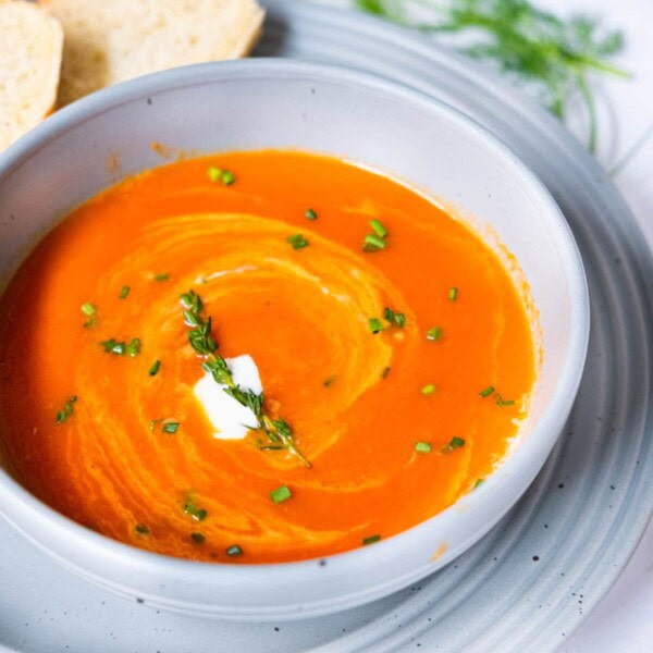 Classic tomato soup served with French bread on the side.