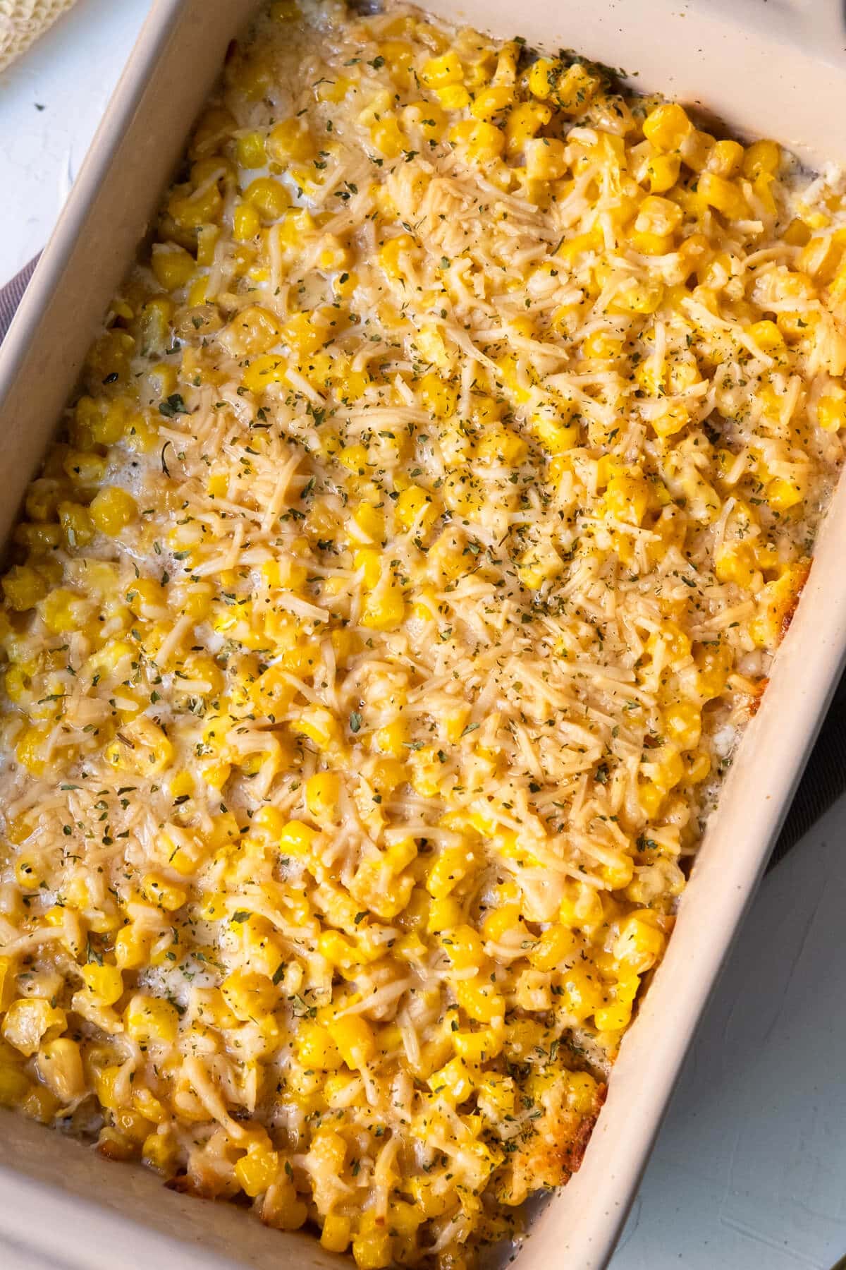 Baked parmesan cheese corn with melted cheese on top.