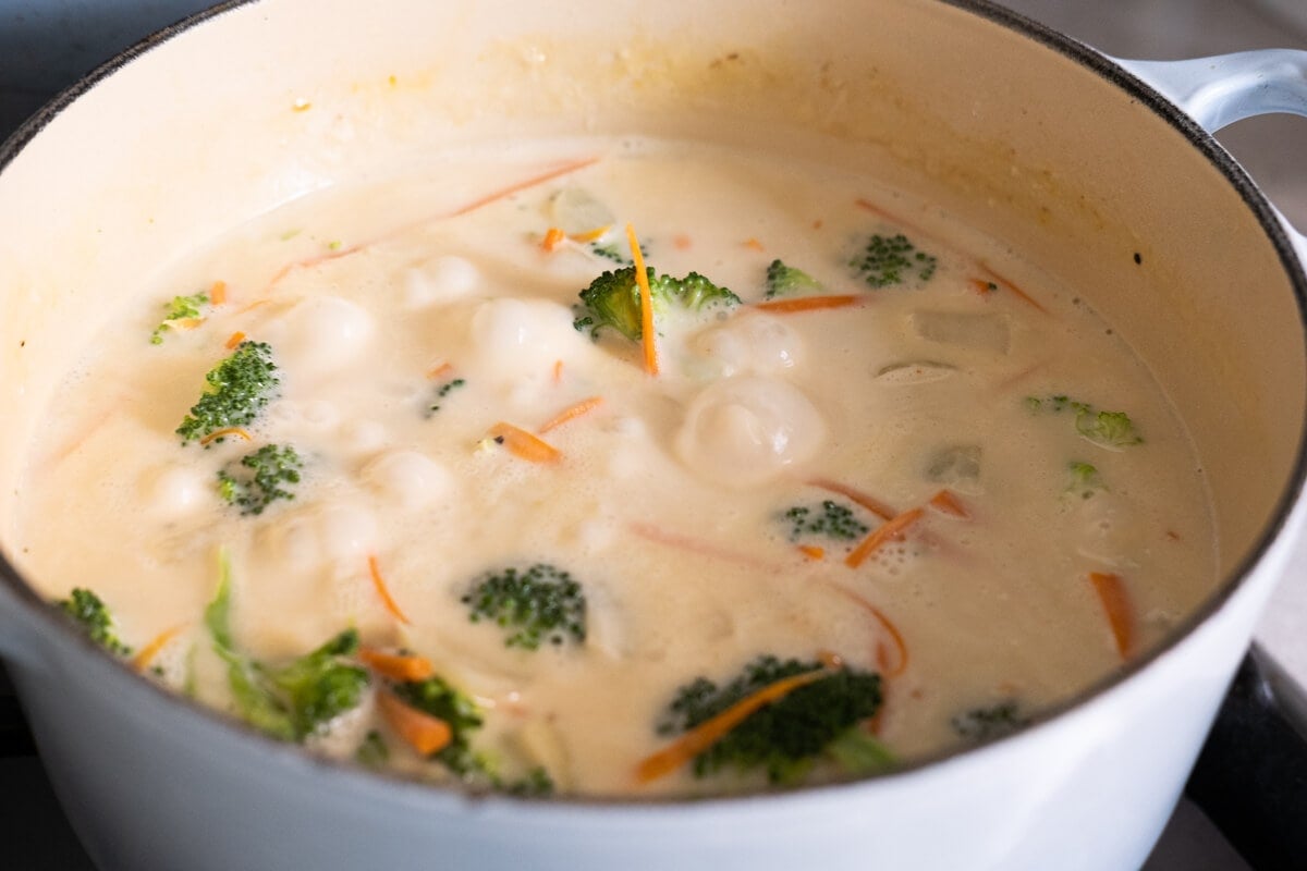 Soup heated with broccoli and carrots in a pot. 