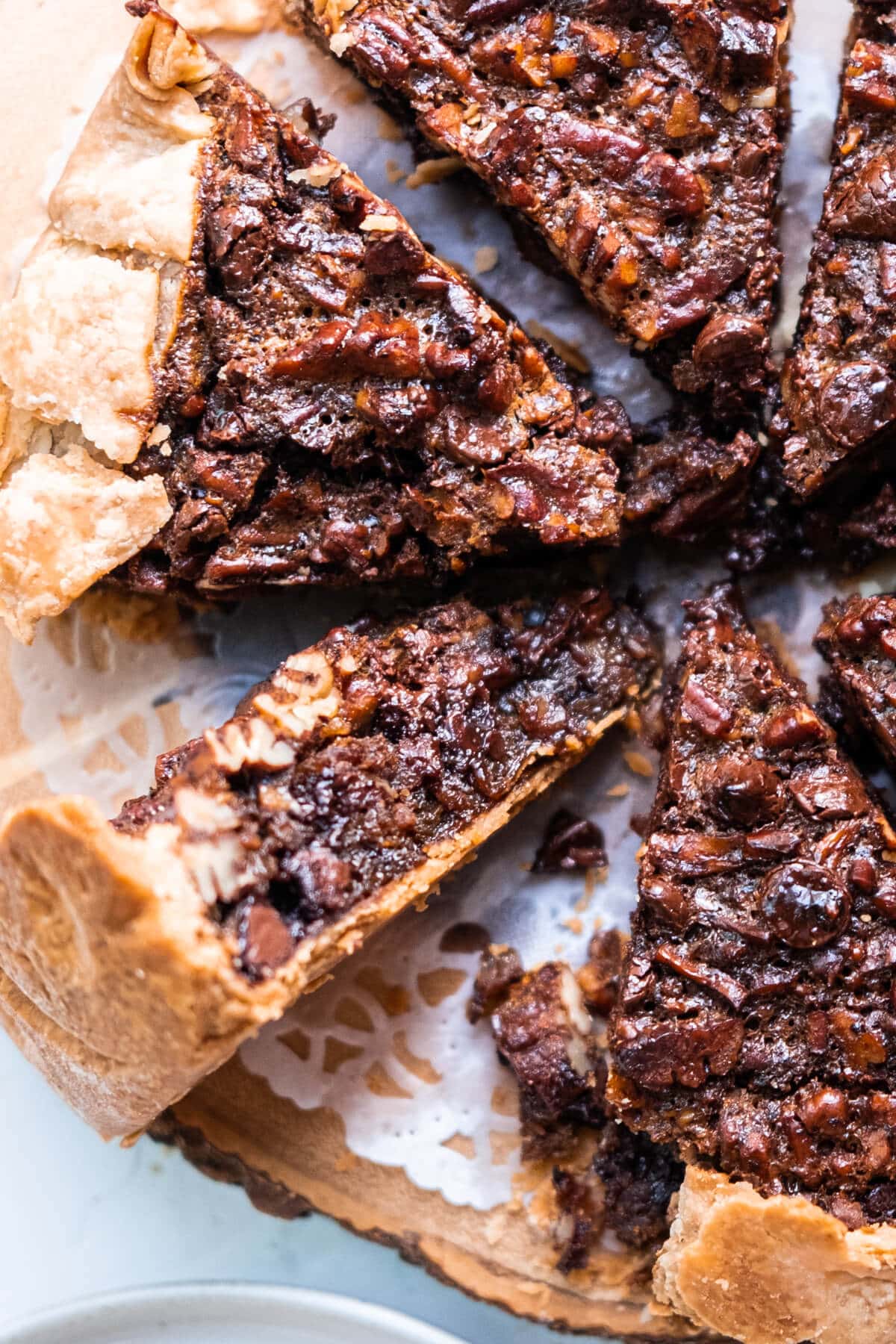 Pieces of pies filled with chocolate chips and pecans with flaky and crumbly crust. 