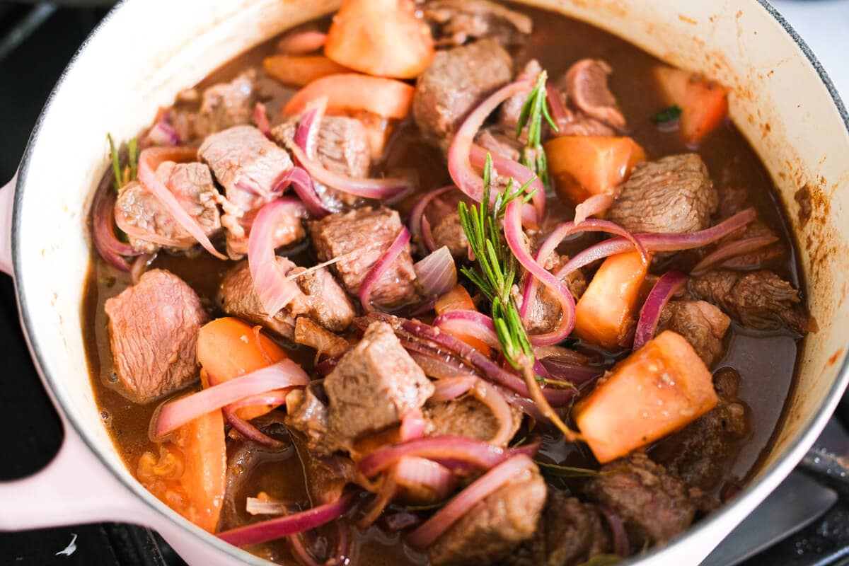 Red wine, beef broth, brown sugar, soy sauce, onion, thyme and beef in the pot.