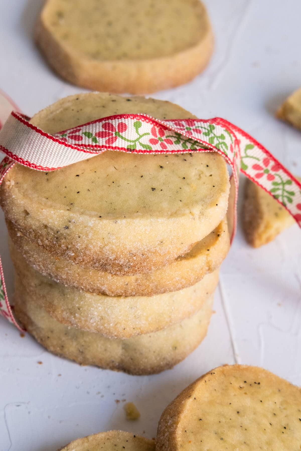 A stack of floral tea flavored cookies  with ribbon wrapped. 