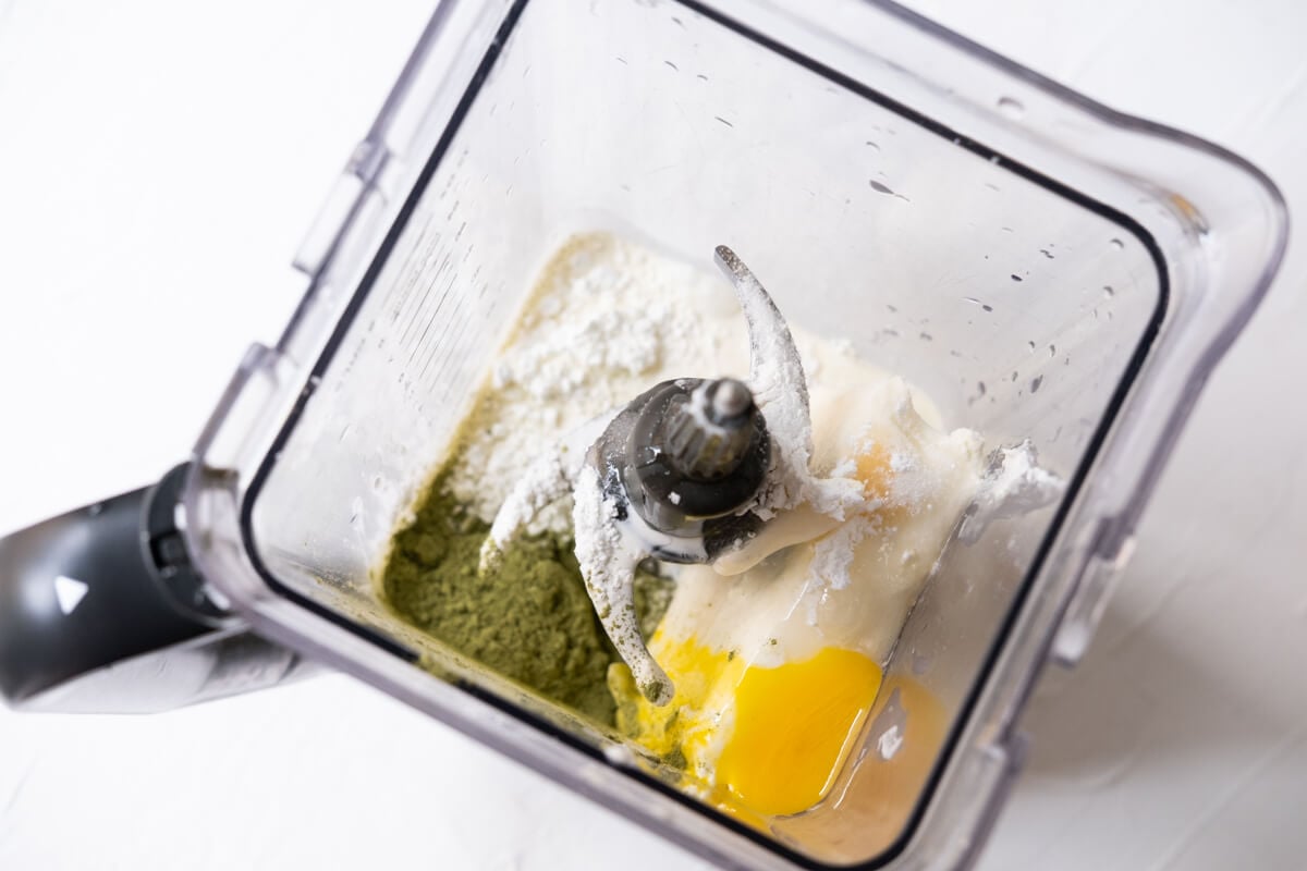 Softened cream cheese, sugar, eggs, egg yolk, heavy whipping cream, vanilla extract, cornstarch, and Matcha powder in a blender. 