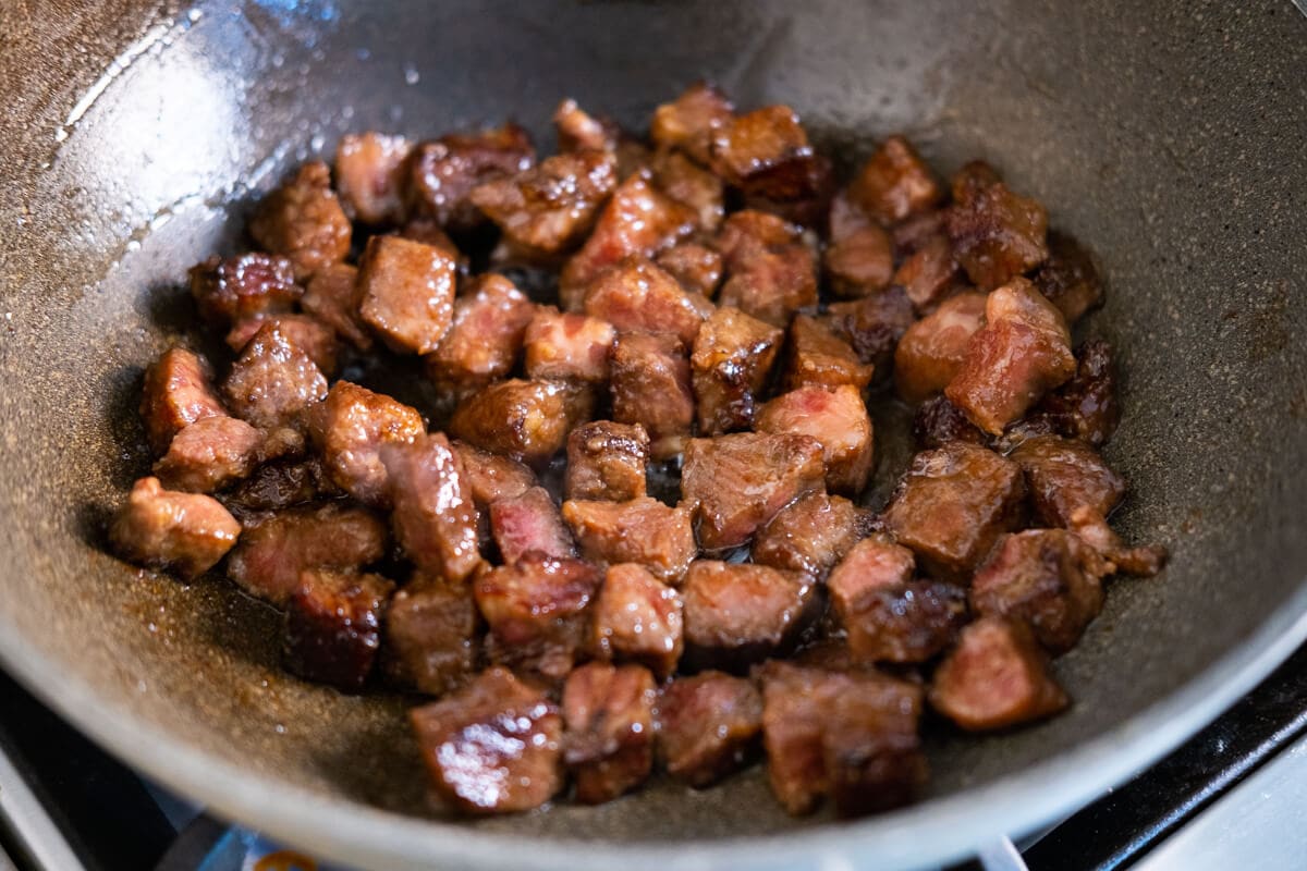 Beef stir fried in a wok. 