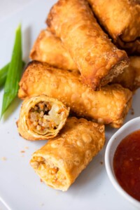 Crispy chicken egg rolls with stir-fried chicken and vegetable fillings.