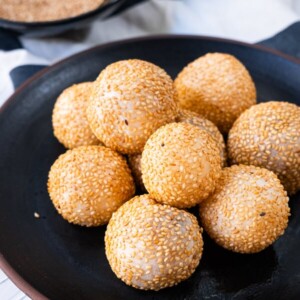 Sesame balls on the black plate.