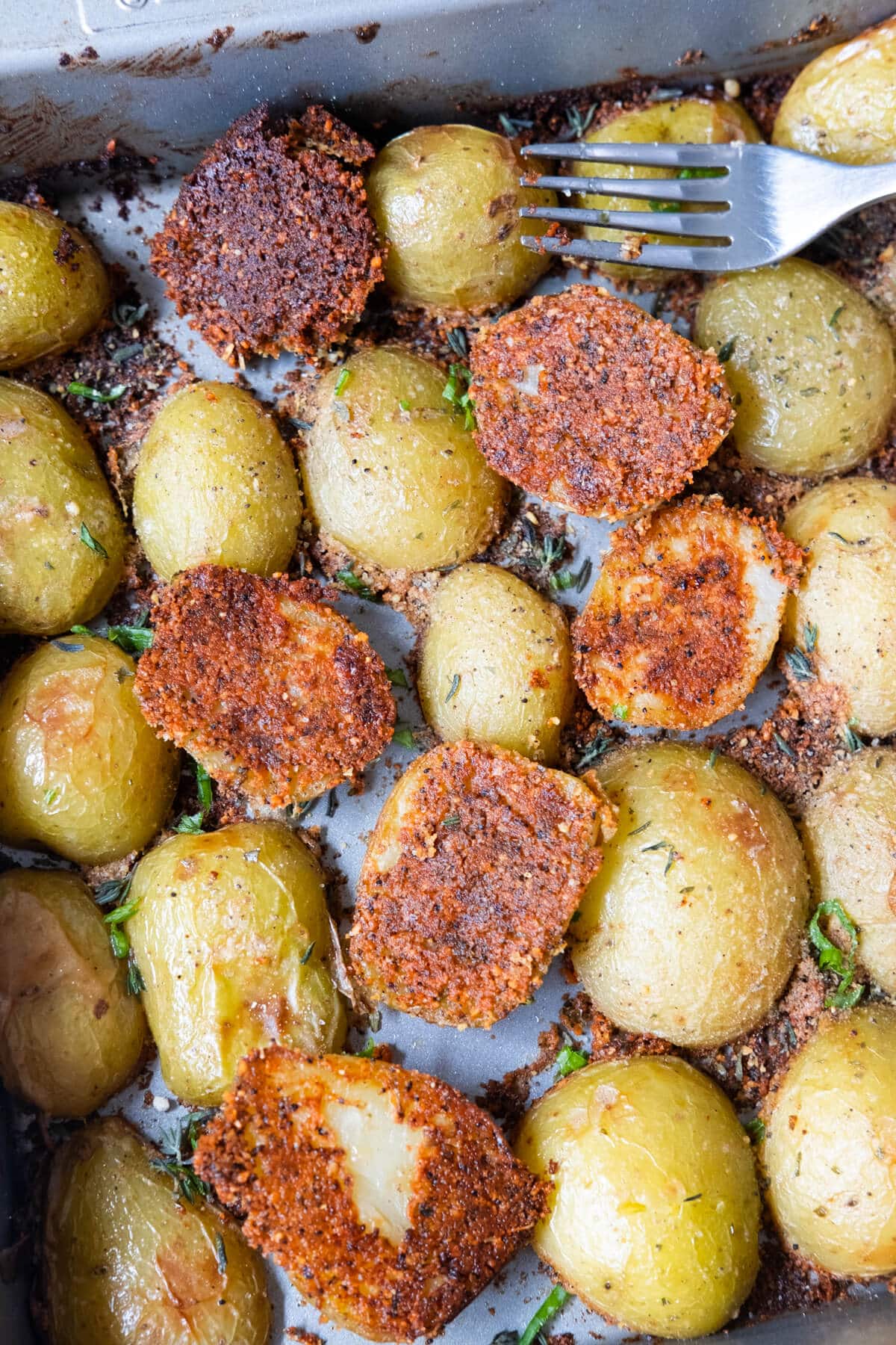 Parmesan crusted potatoes are baked in a 9"x9" baking tray. 