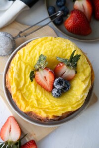 4 ingredients greek yogurt cake with strawberries and blueberries on top.