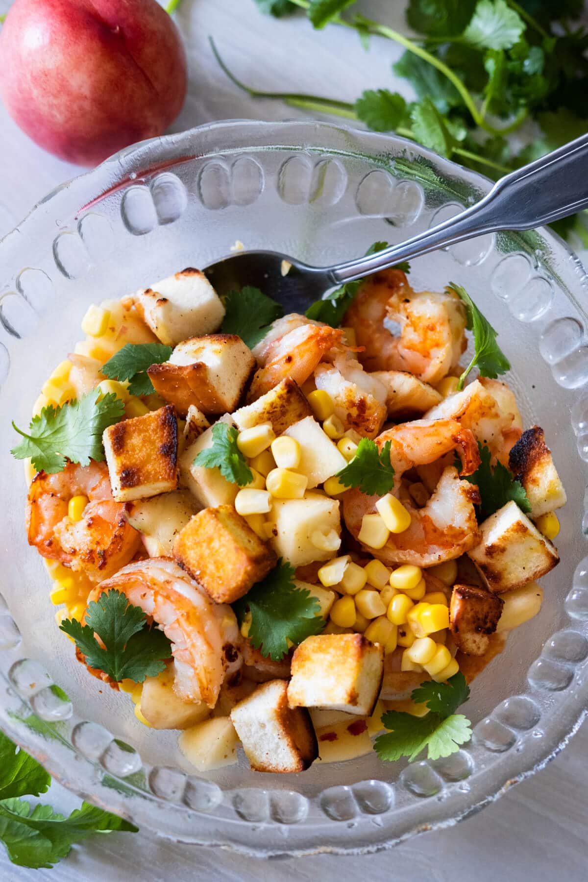 Prawn salad with peach, cilantro, and peach aside.