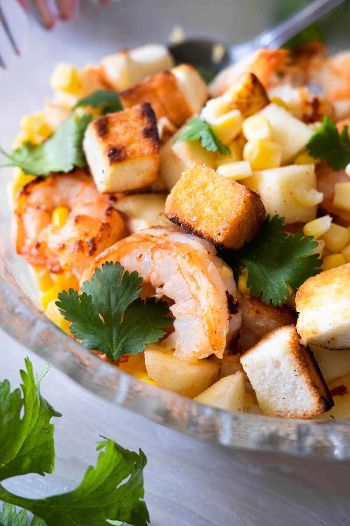 Succulent prawns with peach, sweet corn, cilantro and crumbled bread.  