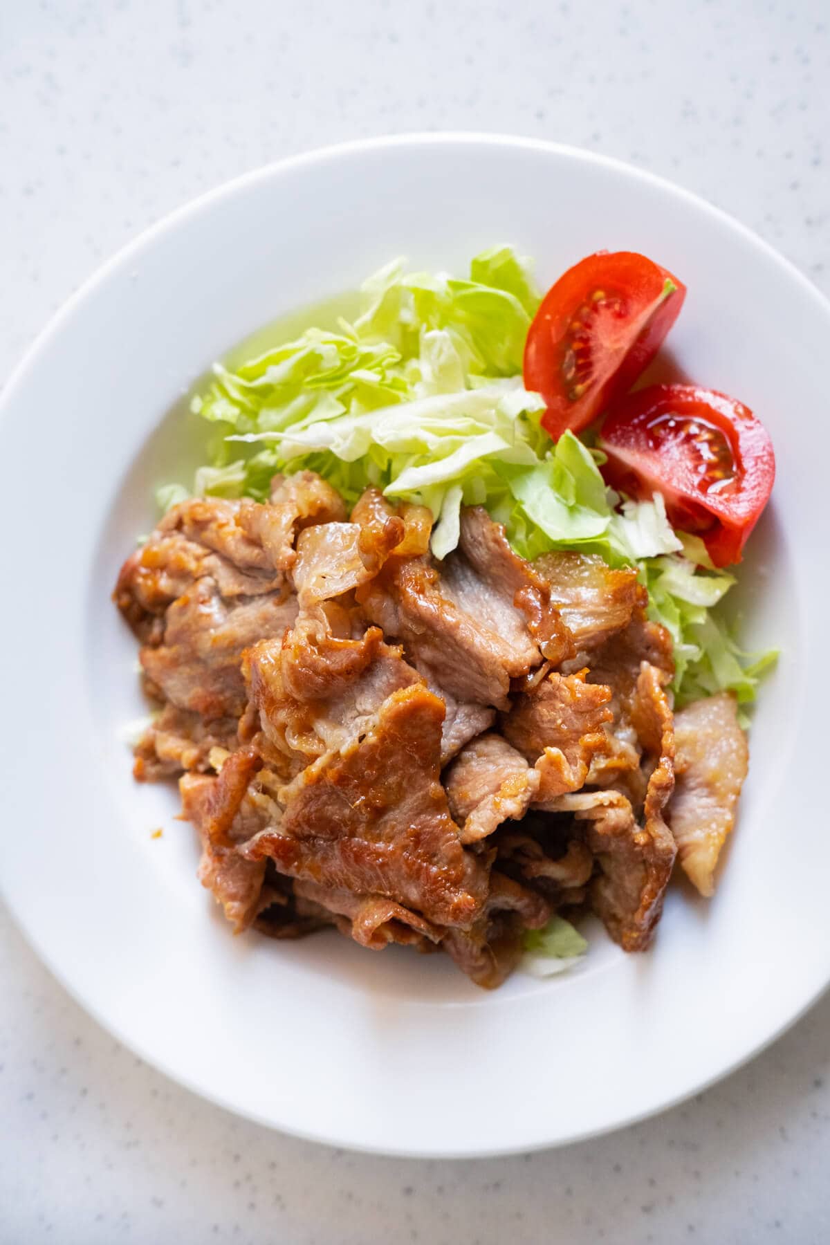 Tender and juicy Japanese ginger pork served in a white plate. 