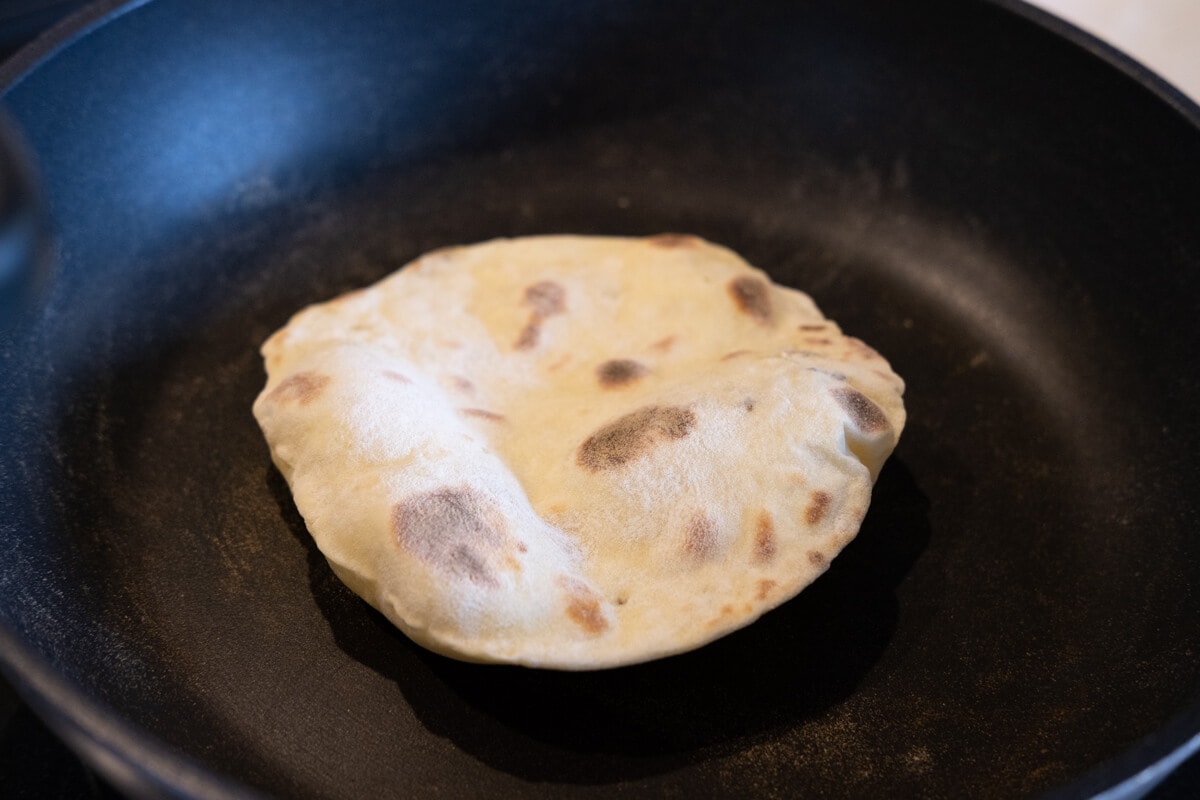 Tortilla placed on a non-stick pan. 