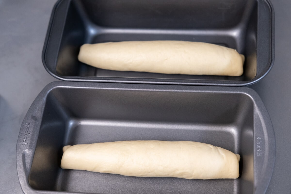 Dough rolled into a log placed into loaf thins. 