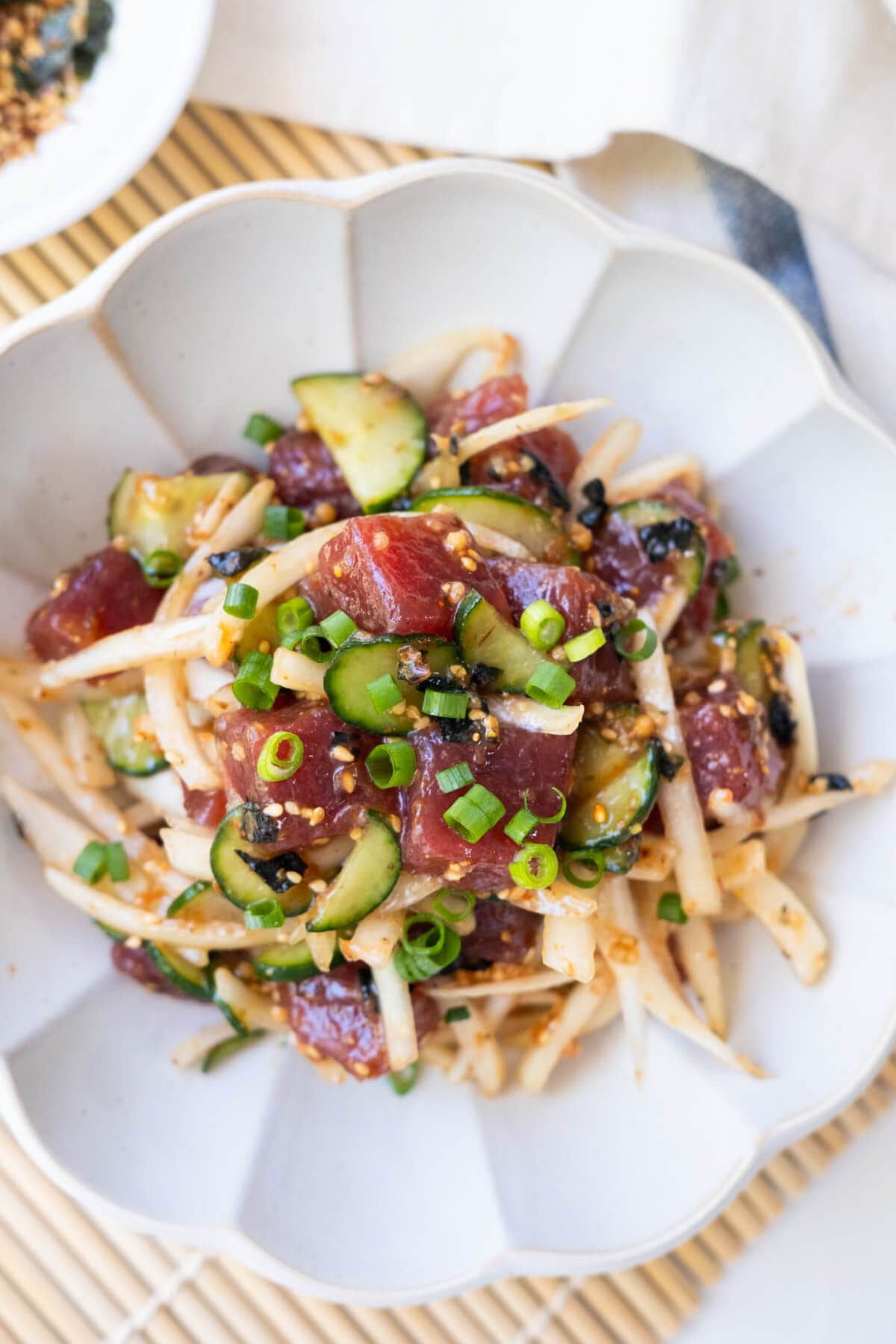 Savory poke bowl made from tuna, yellow onion and cucumber. 