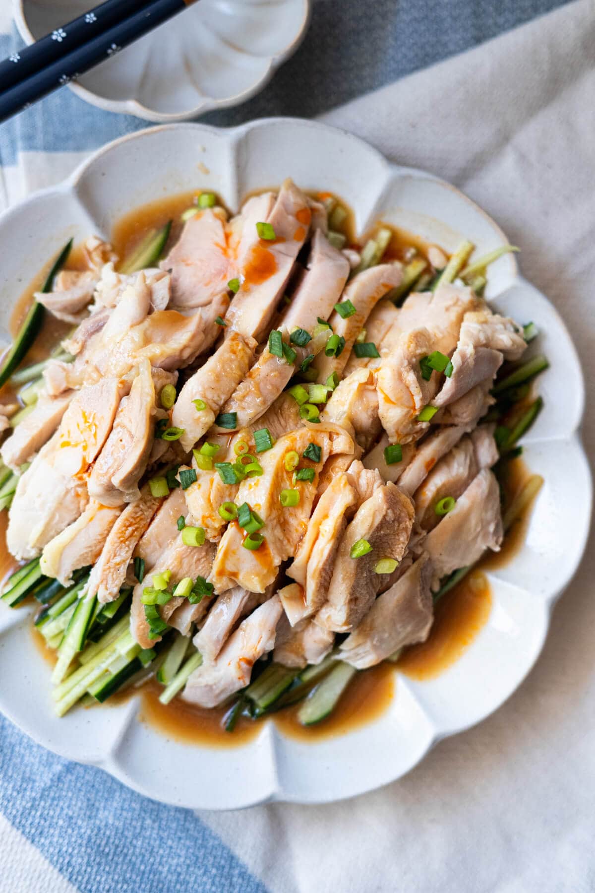 Bang bang chicken with cucumber and sesame sauce served on a plate. 