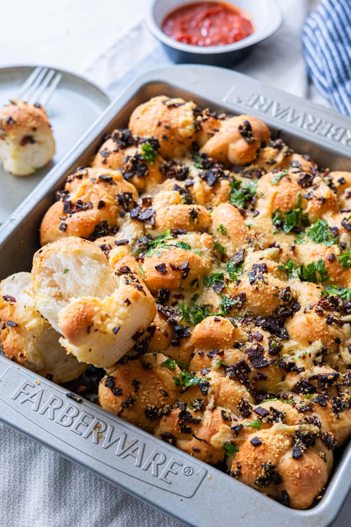 Pepperoni garlic knots served with pizza sauce on the side. 